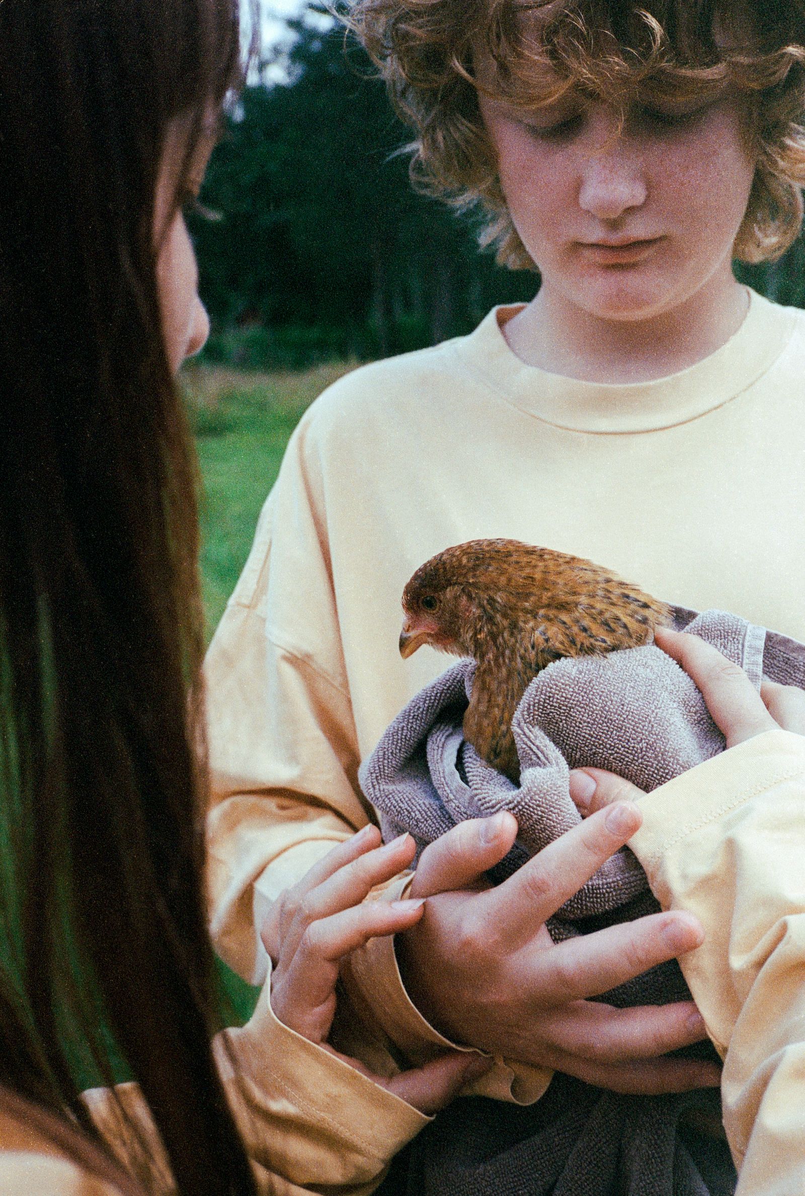 Images may contain facial human photography portrait animal beak teenager grass and plants