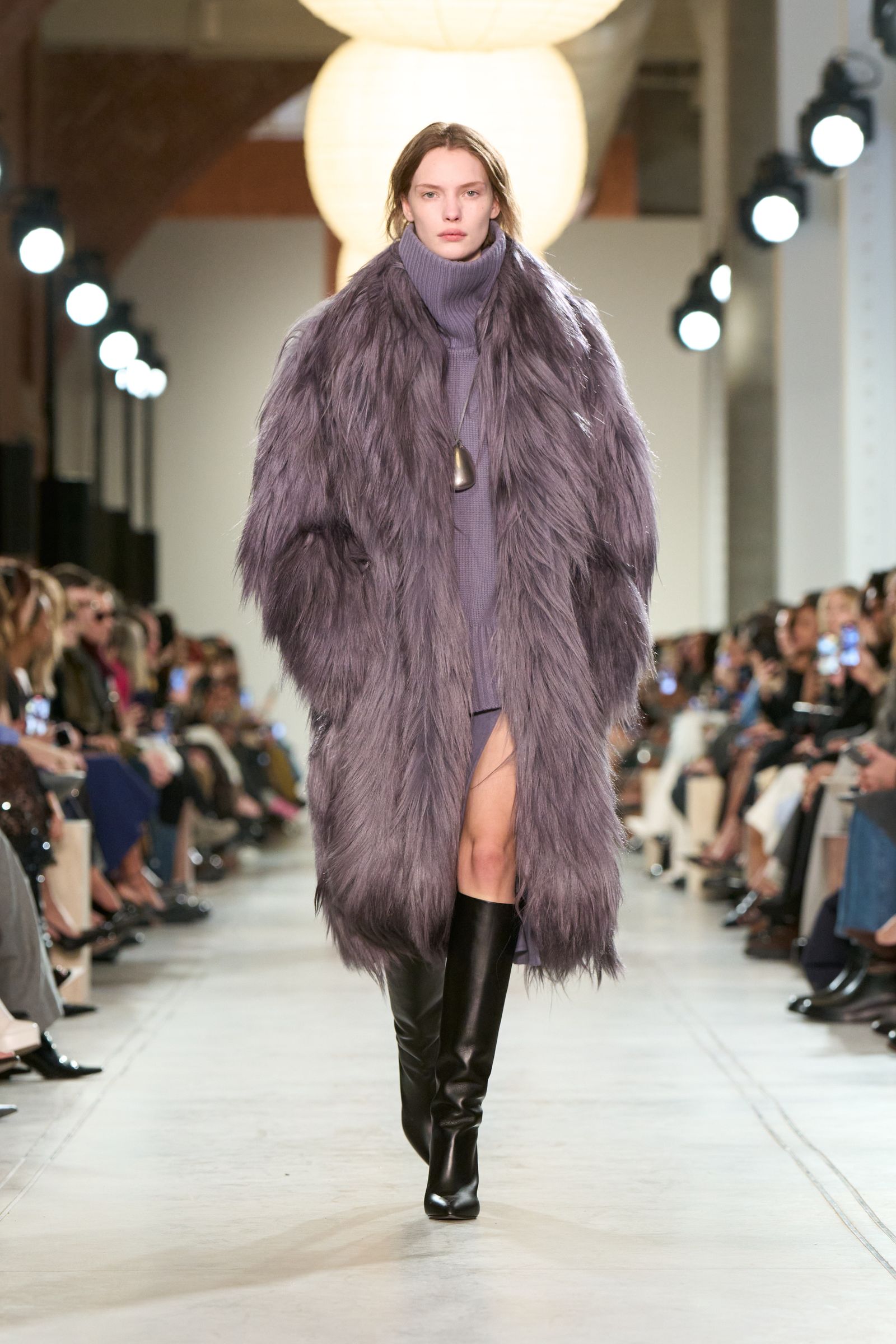 Images may contain Polina Kuklina clothing coat adult fashion shoes electronics and mobile phones