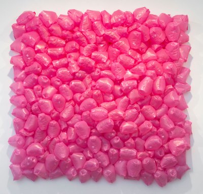 A square sculpture composed of expanded pink plastic bags. 