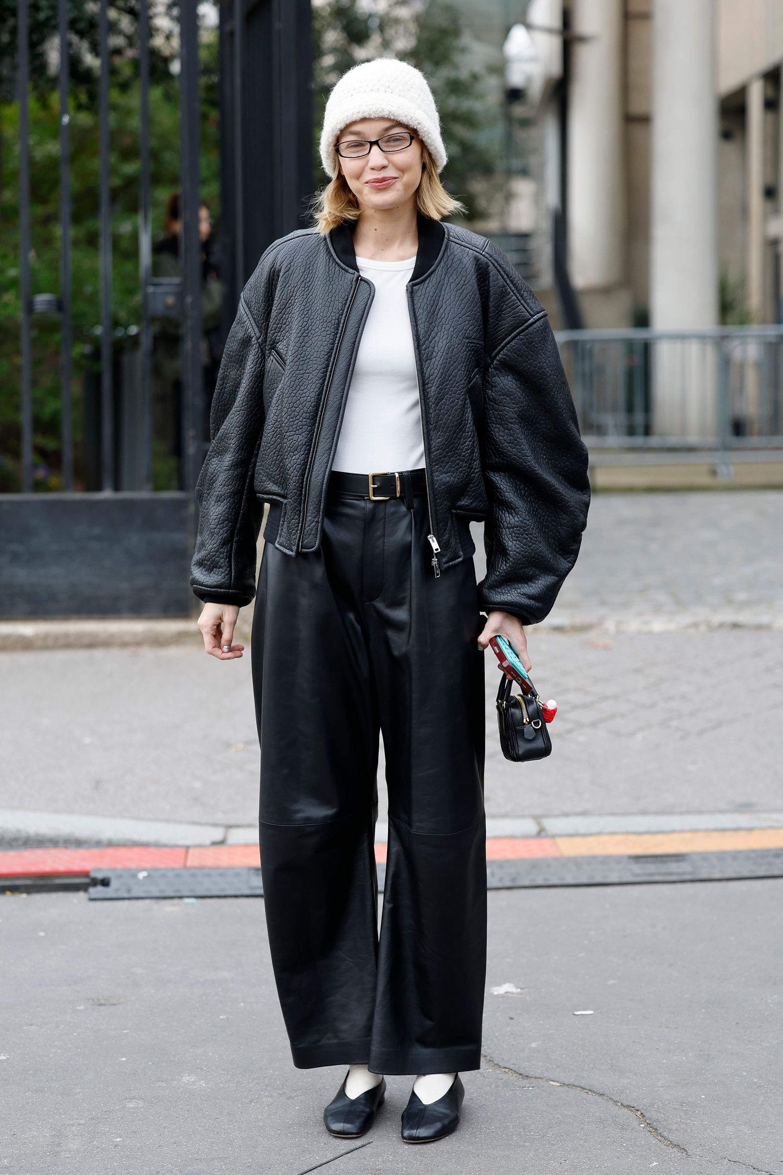 Image may contain Gigi Hadid men clothing jacket pants standing adult accessories glasses belt and hat