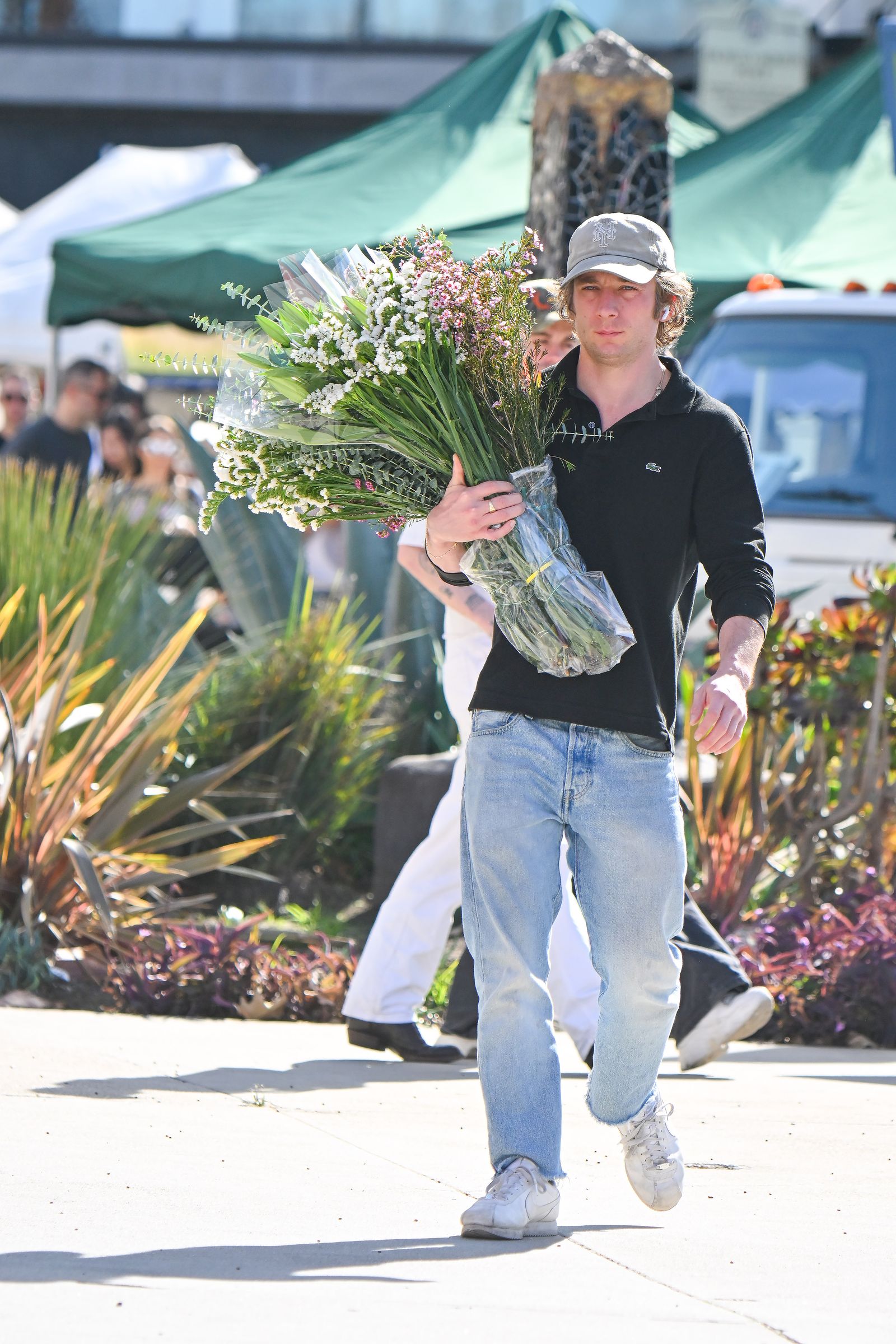 Images may contain Jeremy Allen Bill Kenny Plant Pot Plant Clothing Pants and Floral Arrangements