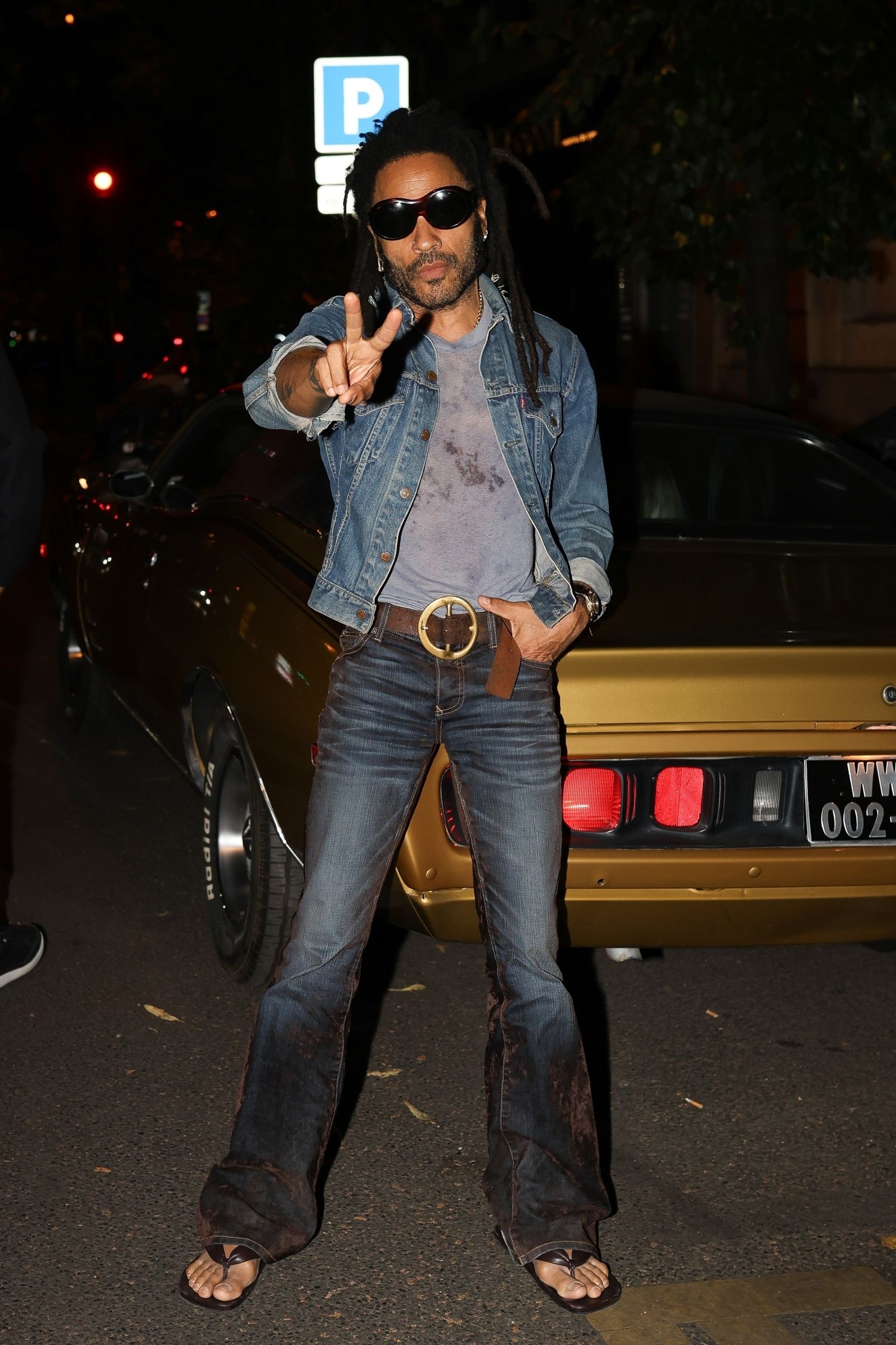Paris France exclusive Lenny Kravitz casually stepped on a pose in front of his amazing Goldyally classic car in Paris...