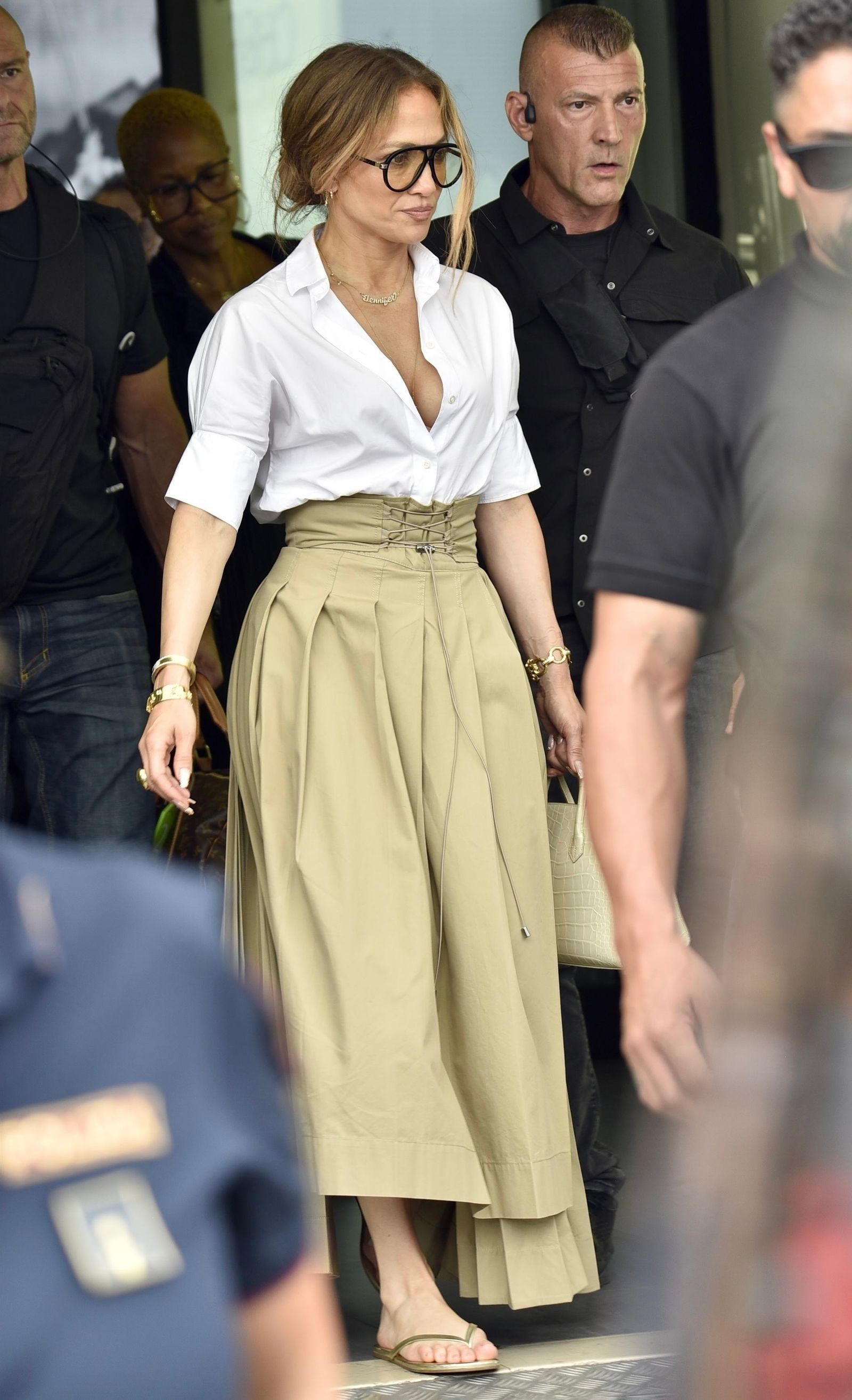 Images may contain Jennifer Lopez personnel accessories glasses clothing shoes adult jewelry and necklaces