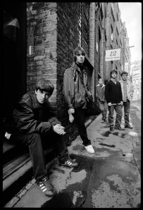 British rock band Oasis (Noel Gallagher, Liam Gallagher, Paul McGuigan, Paul Arthurs, Tony McCarroll) on Flitcroft ST on London WC2, March 15, 1994