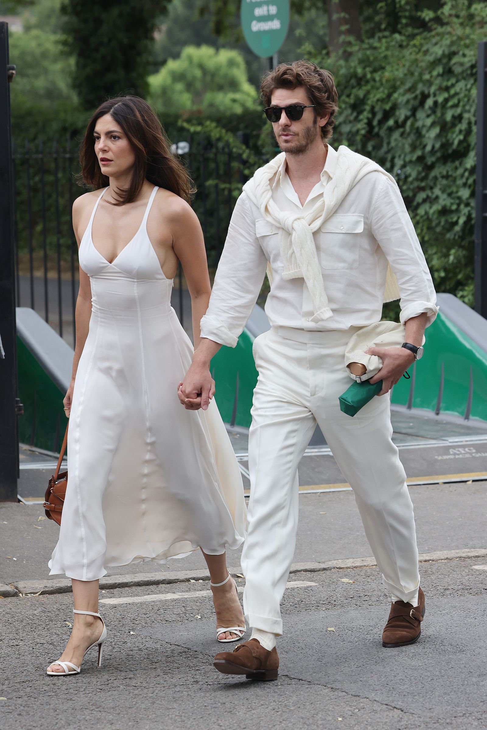 Images may contain Andrew Garfield Monica Barbaro clothing footwear high heel accessories glasses and body parts