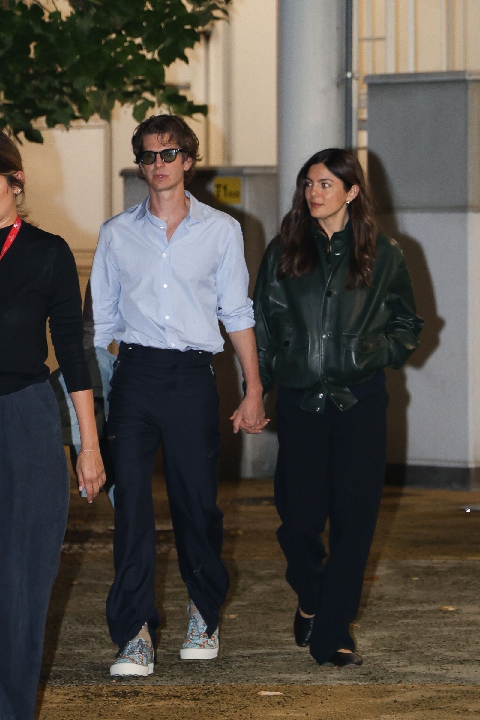 Andrew Garfield and Monica Barbaro go hand in hand