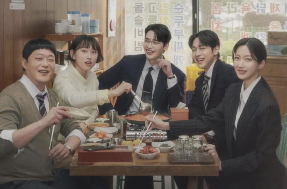 Five lawyers sit on a bubbling hotpot in a Korean restaurant.