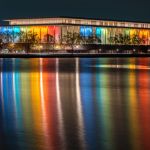 The exterior of the John F. Kennedy Center at the Performing Arts Building is reflected in the Potomac River in Washington, D.C. in 2024