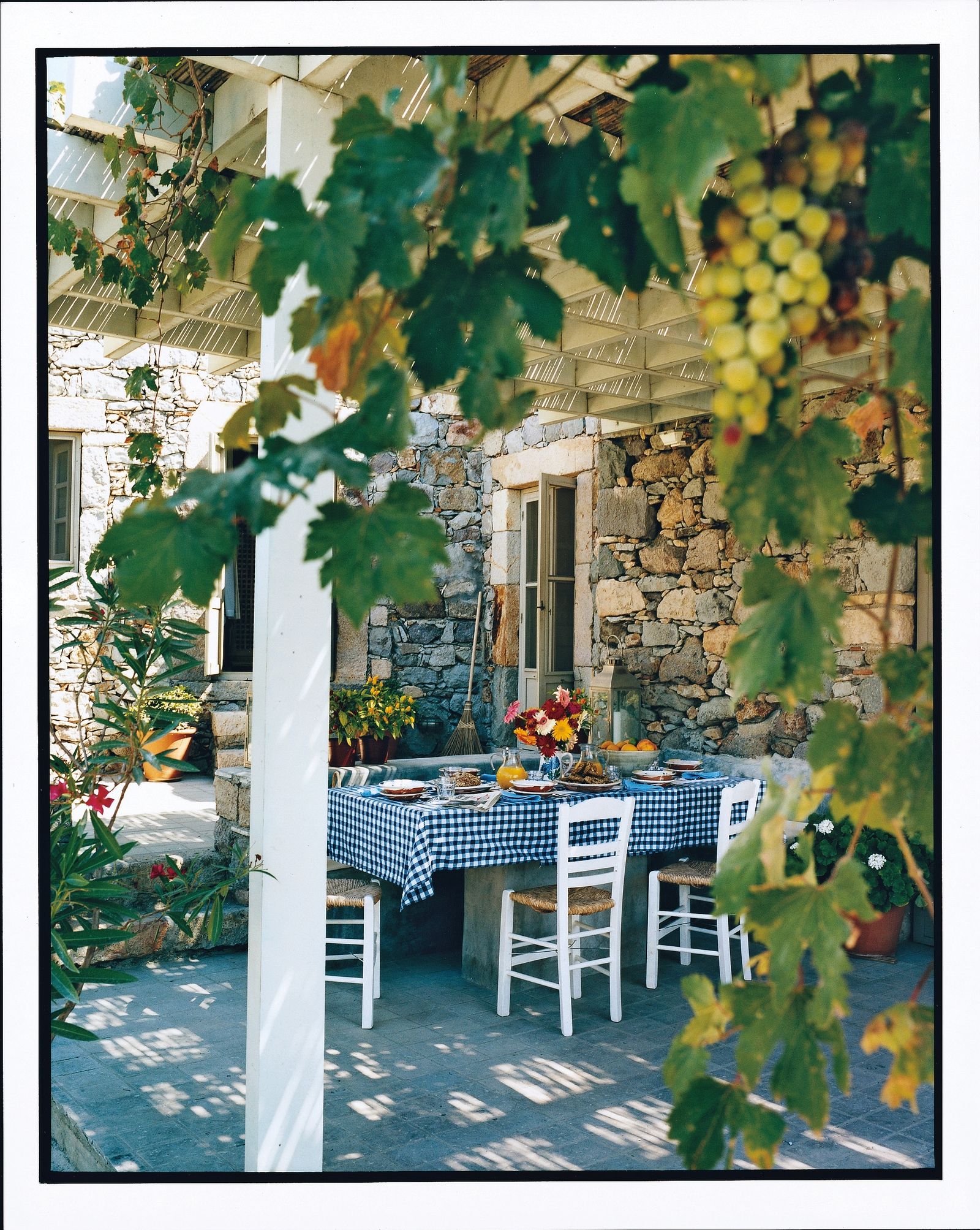 Images may contain dining table furniture table building building house house terrace porch and plants
