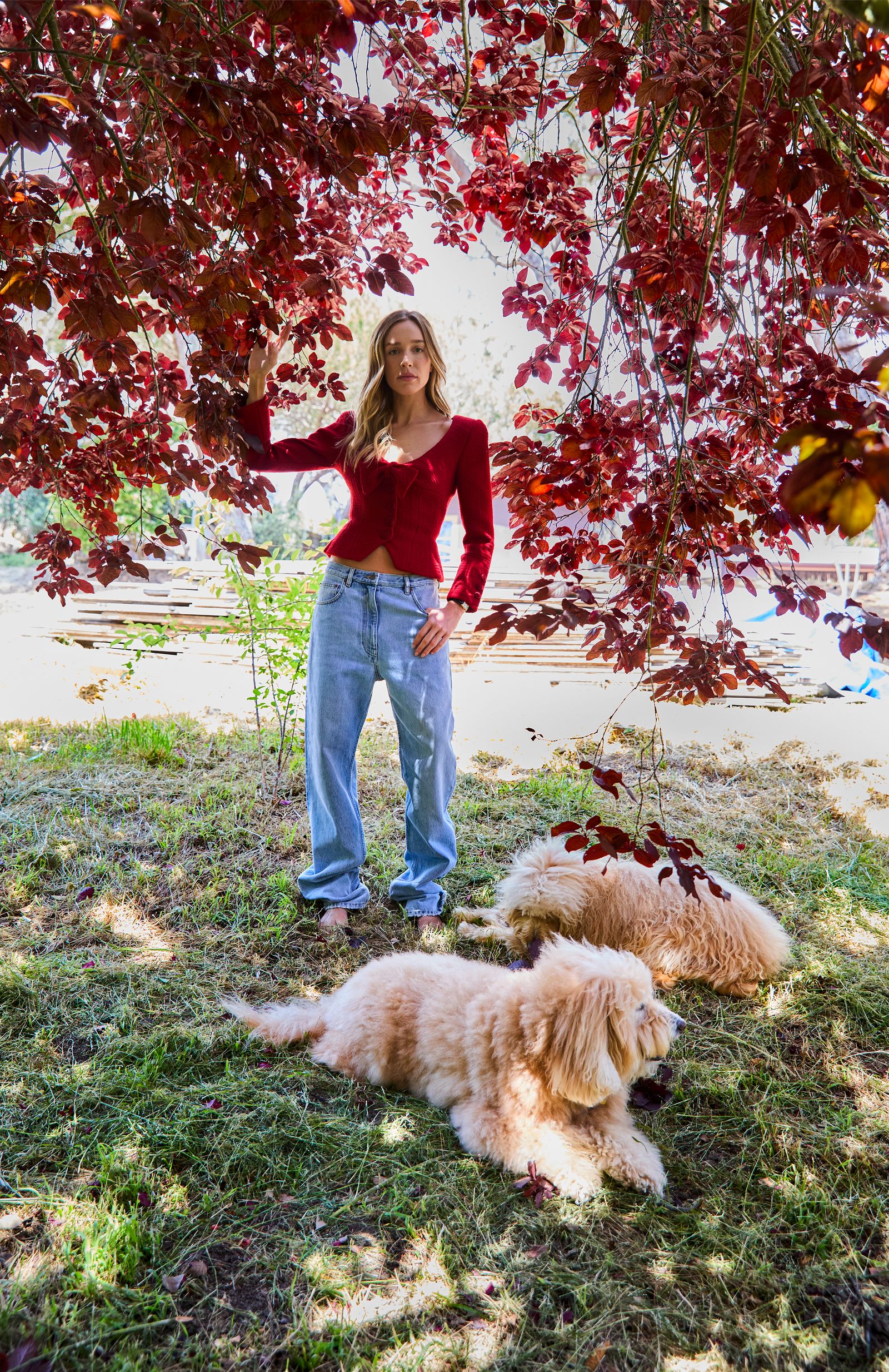 Image may contain clothes pants face people photography portrait jeans grass plant vegetation and teenagers