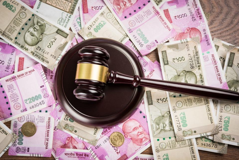 Stock photo of Indian currency rupee with law gavel isolated on white, concept showing Indian financial law, paper money for 500,2000, gavel and Indian flag
