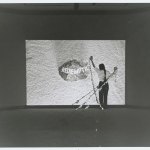 An archive photo showing a woman holding three strings before the movie projection, which read 