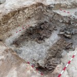 A deep tomb with ancient ruins at the bottom.