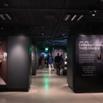 People wandered in a set of museum galleries, reading 
