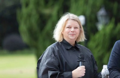 A woman holding a microphone.