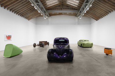 The sculpture resembles the cars around the gallery.