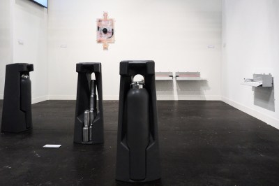 Sculptures resembling Citi Bike docking stations with rounded bollards inside.