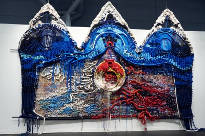 A large scale textile work made of shipping lines and industrial rope that resembles an open, triptych altarpiece.