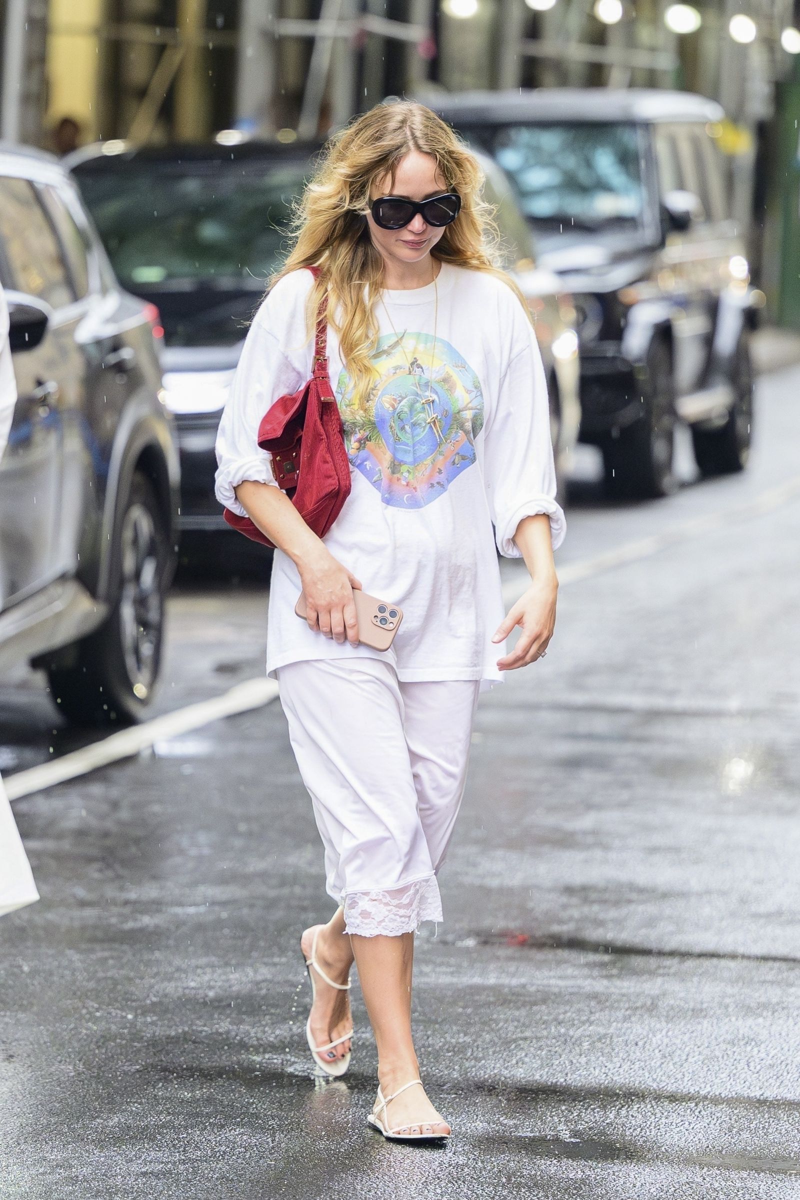 Images may contain Jennifer Lawrence clothing pants pedestrian adult accessories handbags and shoes