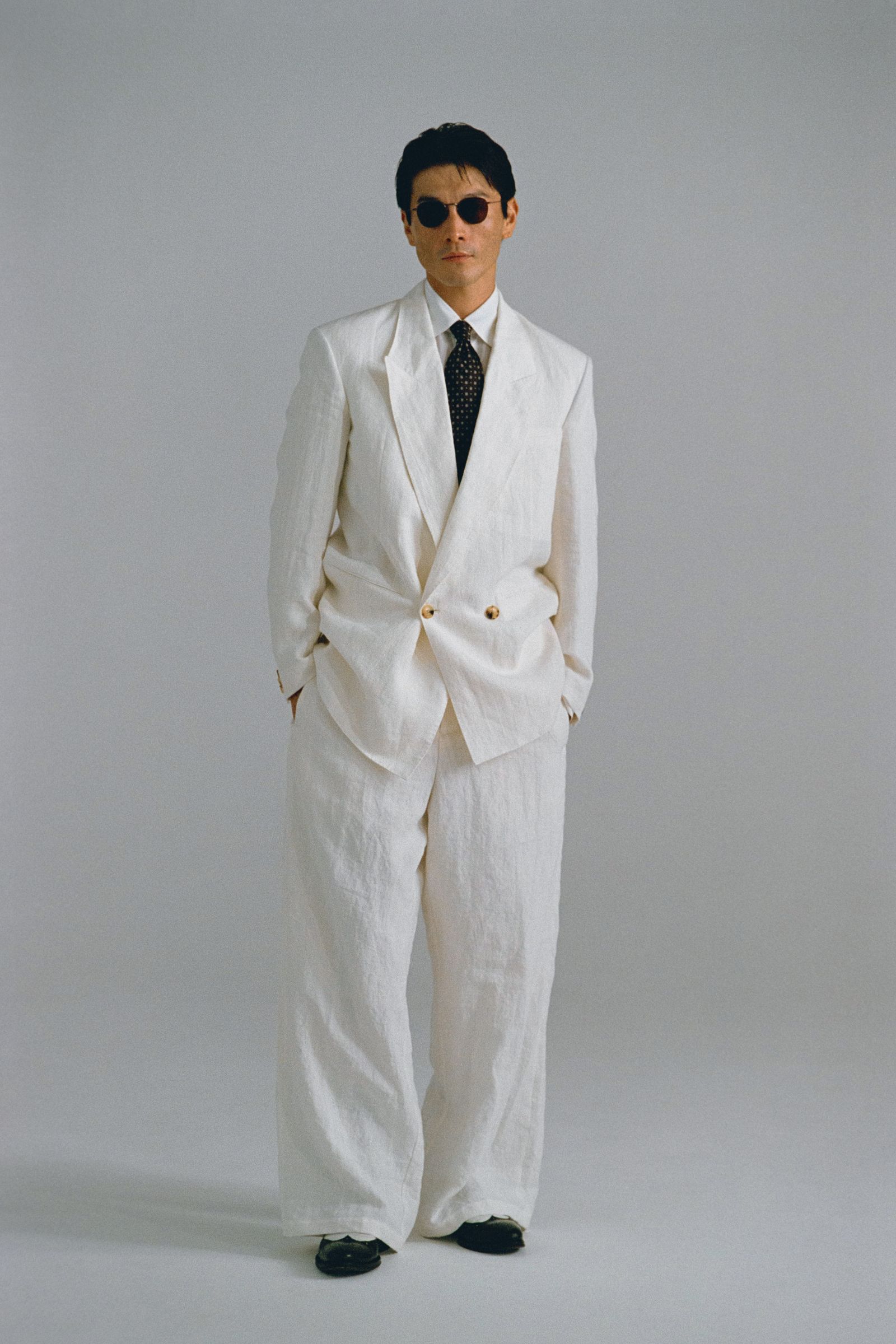 Images may contain clothing formal wear suit tuxedo jacket coat home decor linen accessories tie and adult