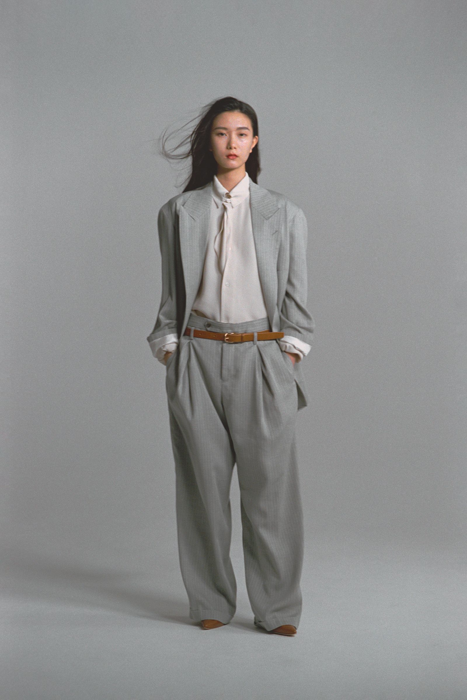 Images may contain clothing formal suit personnel accessories belt trousers jacket coat home decor and linen