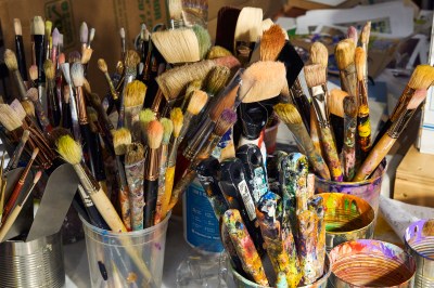 Photos of dozens of brushes in a studio. 