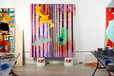 An abstract painting in the process is located on two Ace buckets. 