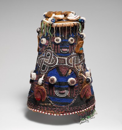 A beaded headdress with big sets of eyes.