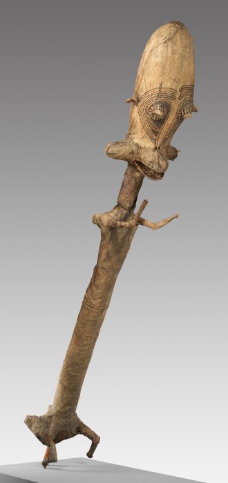 A long headdress with an elongated face and tiny arms.