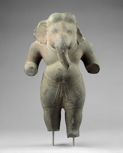 A sculpture of an elephant-headed person in a wrap-like skirt.