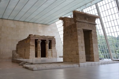 An ancient temple in a light-filled room with a large glass window.