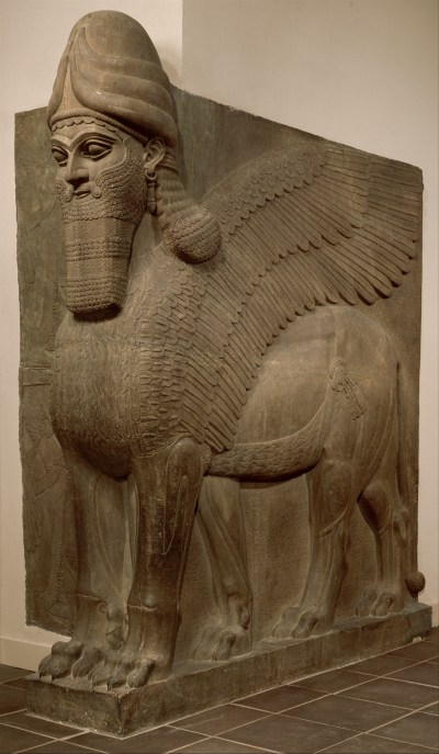 A statue of a winged lion figure with a human man's face.