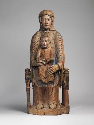 A wood sculpture of an enthroned Virgin Mary holding her child on her lap.