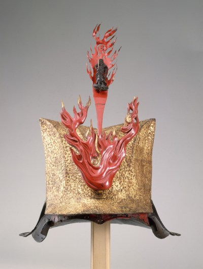 A golden helmet with a sculpted blaze of fire rising from it.