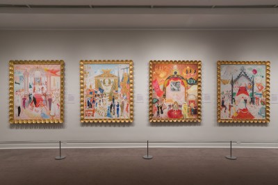 Four paintings hanging on a wall.