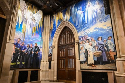 The new murals painted on the North and West panels seen here by artist Adam Cvijanovic were unveiled in New York on Wednesday, September 17, 2025 at St. Patricks Cathedral. The mural is the largest permanent work of art commissioned for the Cathedral in its 146-year history, celebrating the 1879 ghost of the door knock in Ireland, the faith of generations of immigrants heading to New York, and the service of the first responders in New York City. (Diane Bondareff/AP Content Services of Archdiocese, New York)