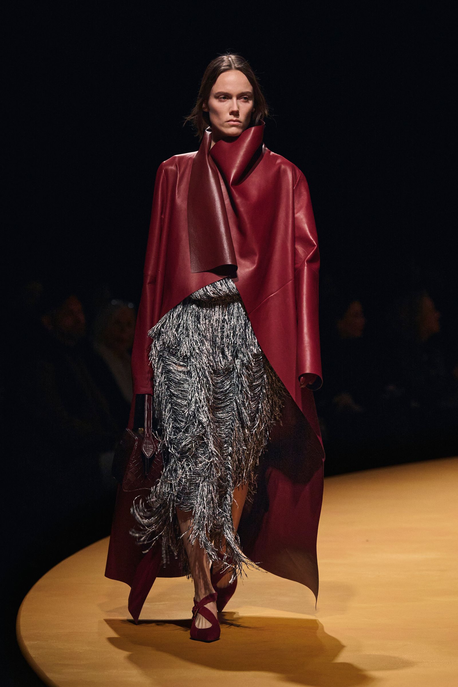 Images may contain stylish adult cape clothing accessories bags and handbags