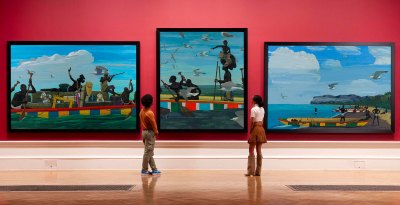 Three paintings hang on the wall of the museum. 