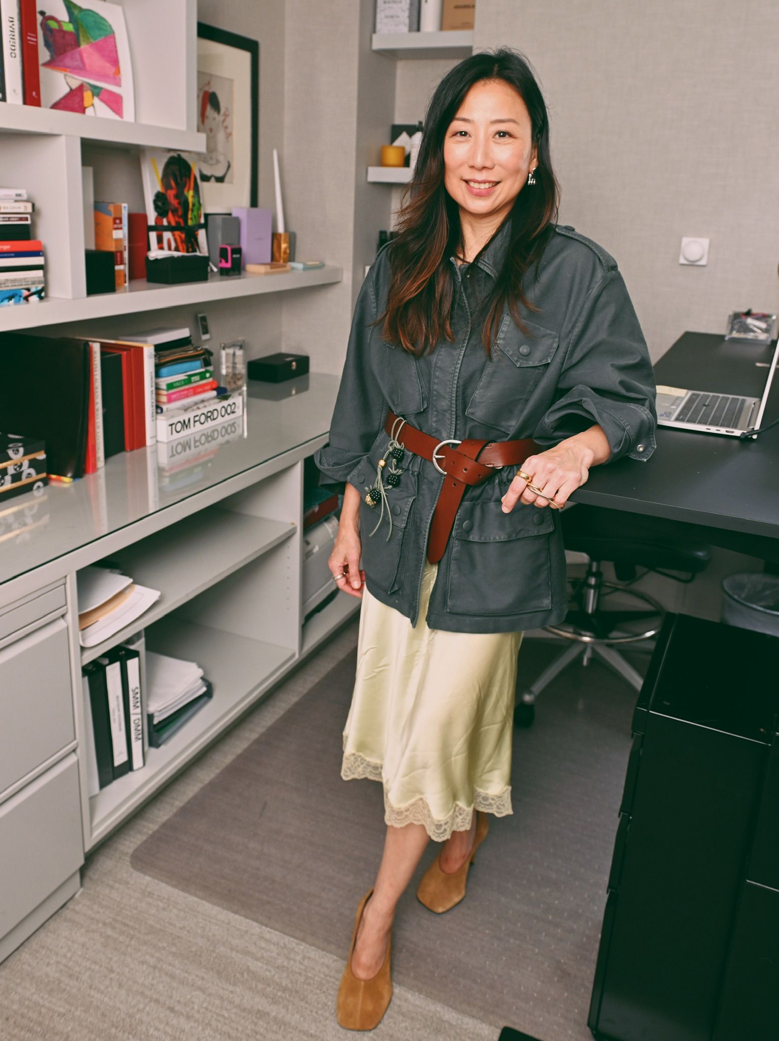 Images may contain Yashan Yoko adult clothing footwear high heels computer electronic laptop and PC