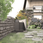Outdoor area with table and stone walls.