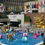 Adults and kids play in Joel Mesler's pool party themed installation, located at 30 Rockefeller Park Plaza.