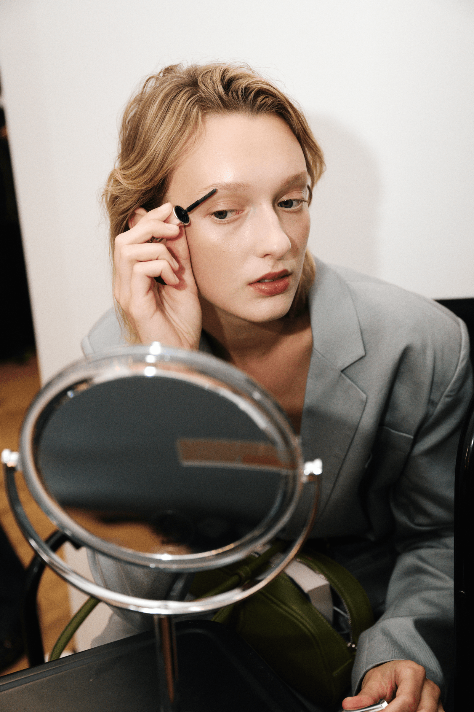 Modeling her own hair and makeup in Rachel Comey