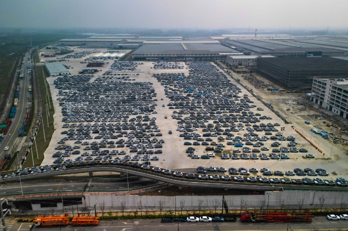 An aerial photo is showing new energy vehicles parked at a parking lot at the BYD Auto factory in Hefei, Anhui province, China