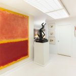 Large abstract Rothko paintings hang on the wall of the house with bronze sculptures in the center and a small Mondrian abstraction on the right.