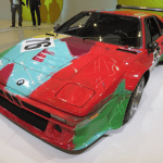 A sports car painted in red, blue, green and purple.