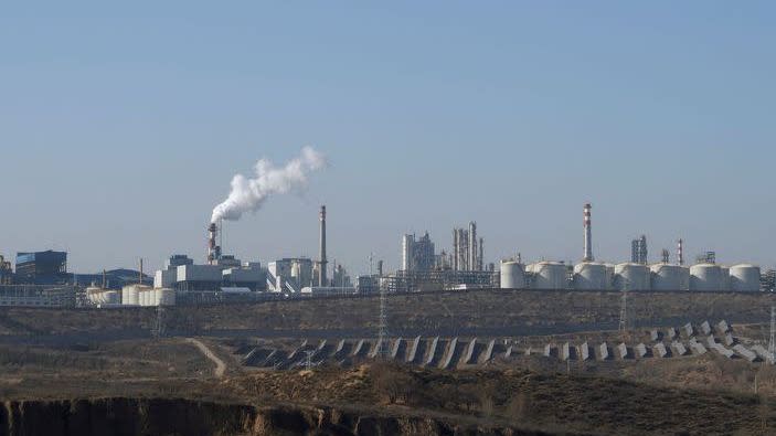 Solar panels are seen in front of the factory in Jinji Industrial Park, Shenmu, China