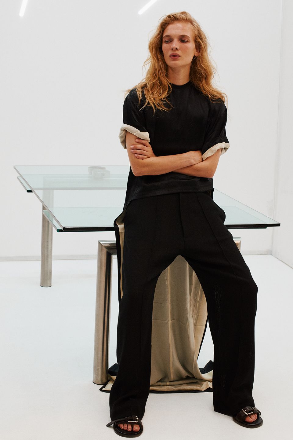 Images may contain furniture table adult sitting table clothing shoes sandals formal wear and pants