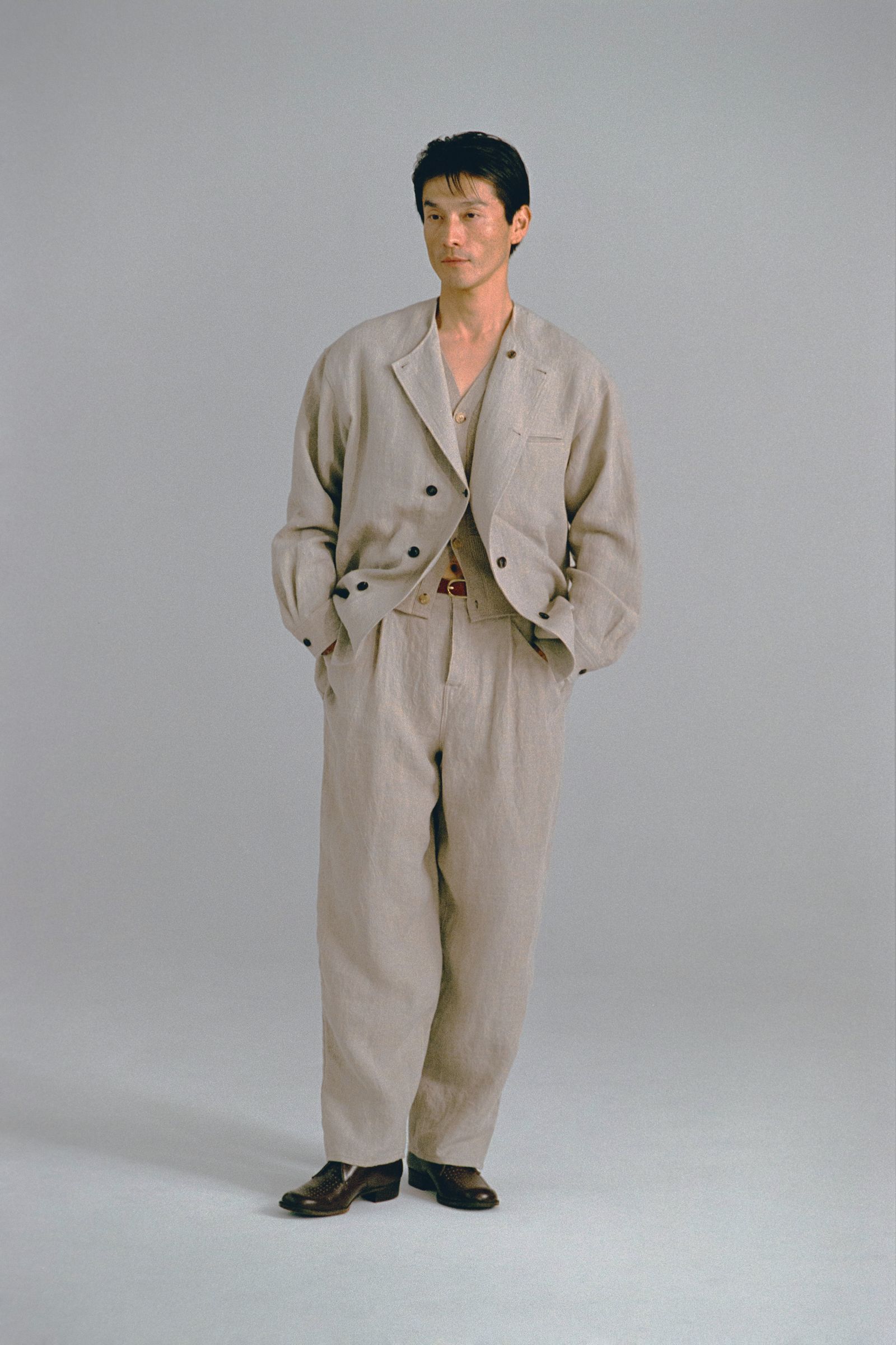 Images may contain Tony Leung Kafai clothing formal clothing jacket adult home decor and linen