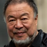 Close-up of artist Ai Wewei smiling.