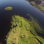 Aerial view of the green island in the middle of the lake.